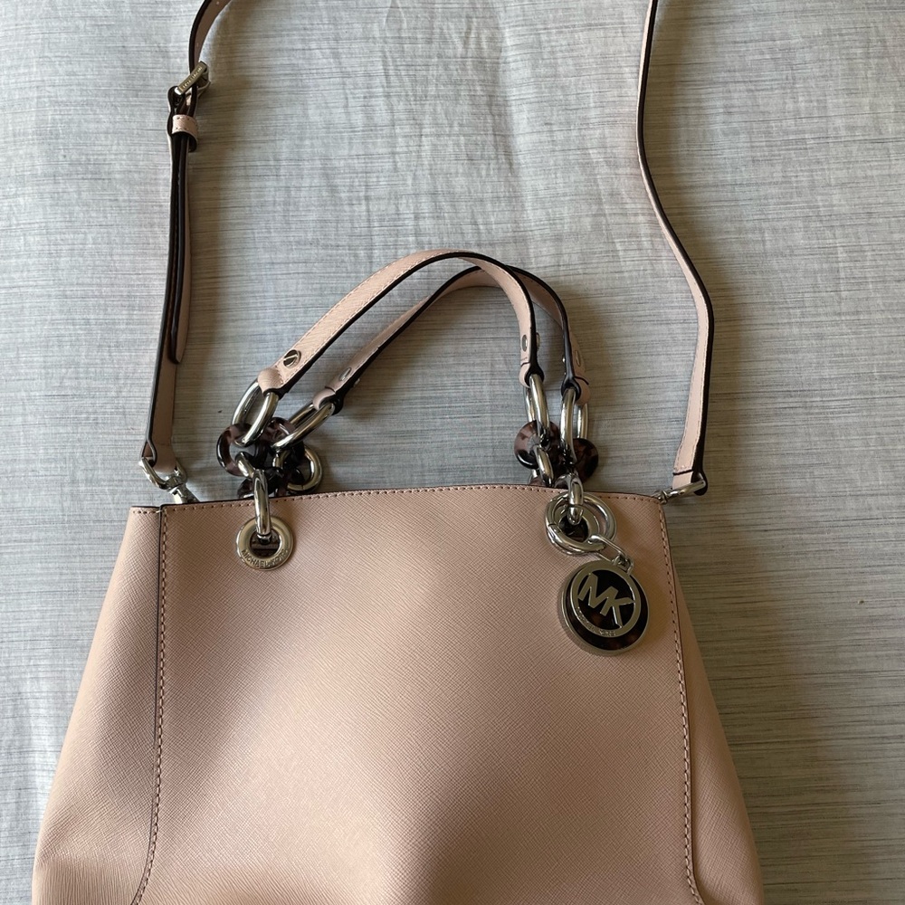 Michael Kors rose beige crossbody bag with leopard print details.